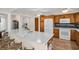 Kitchen featuring light countertops, wooden cabinetry and island seating with open access to living areas at 2814 Lomond Dr, Palm Harbor, FL 34684
