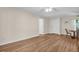 Spacious living room with light-colored walls and baseboards, ceiling fan, and wood-look flooring at 2814 Lomond Dr, Palm Harbor, FL 34684