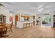 Open concept living room and kitchen area with light colored flooring and ceiling fans at 2814 Lomond Dr, Palm Harbor, FL 34684