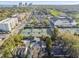 Aerial view features neighborhood homes adjacent to tennis courts, commercial buildings, and cityscape at 2815 W Estrella St, Tampa, FL 33629
