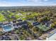 Aerial neighborhood view shows homes next to a golf course, pool, and tennis courts with parking at 2815 W Estrella St, Tampa, FL 33629