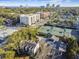 Aerial view showcases neighborhood near tennis courts with commercial buildings and city skyline at 2815 W Estrella St, Tampa, FL 33629