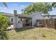 Backyard features a covered patio with seating, landscaping, and a privacy fence with access to the home at 2815 W Estrella St, Tampa, FL 33629