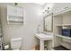 Bathroom featuring a pedestal sink, toilet, and storage at 2815 W Estrella St, Tampa, FL 33629
