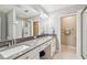 Bright bathroom featuring double sinks, sleek countertops, and a glass-enclosed shower at 2815 W Estrella St, Tampa, FL 33629