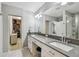 Bathroom featuring double sinks, modern fixtures, and an entrance to a walk-in closet at 2815 W Estrella St, Tampa, FL 33629