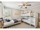 Bedroom with a bunk bed, hardwood floors, and lots of light from the windows at 2815 W Estrella St, Tampa, FL 33629