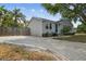 Charming single-story home with a cozy front porch, blue front door, and mature landscaping at 2815 W Estrella St, Tampa, FL 33629