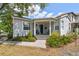 Charming home with a covered porch, quaint landscaping, and a welcoming entrance at 2815 W Estrella St, Tampa, FL 33629