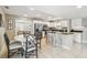 Bright kitchen with stainless steel appliances, granite countertops, and a dining table with seating for four at 2815 W Estrella St, Tampa, FL 33629