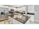 Bright kitchen with an island with granite countertops, white cabinets and stainless steel appliances at 2815 W Estrella St, Tampa, FL 33629