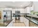Bright kitchen featuring stainless steel appliances, granite counters, and white cabinets at 2815 W Estrella St, Tampa, FL 33629