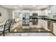 Bright kitchen with granite countertops, stainless steel appliances, an island, and a connected dining area at 2815 W Estrella St, Tampa, FL 33629