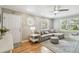 Bright living room with hardwood floors, large windows, and a comfortable seating arrangement at 2815 W Estrella St, Tampa, FL 33629