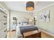 Elegant bedroom with hardwood floors, bedside tables, chest, and decorative mirrors at 2815 W Estrella St, Tampa, FL 33629