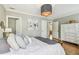 A serene bedroom featuring a plush bed, white dresser, light walls and hardwood flooring at 2815 W Estrella St, Tampa, FL 33629