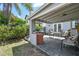 Comfortable outdoor patio features a brick fireplace and furniture for relaxing and entertaining with a well-maintained fence at 2815 W Estrella St, Tampa, FL 33629