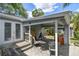 Back patio area with brick under cover and a well kept back yard at 2815 W Estrella St, Tampa, FL 33629