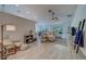 Bright living room with a ceiling fan, light walls, light wood-look floors and dining area at 28834 Stormcloud Pass, Wesley Chapel, FL 33543