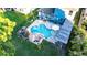 Aerial view of the pool, outdoor kitchen and bar, and backyard lawn with game at 30647 Walker Cup Pl, Wesley Chapel, FL 33543