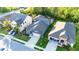 Aerial view of a blue single-Gathering home in a neighborhood, with well-kept lawns at 30647 Walker Cup Pl, Wesley Chapel, FL 33543