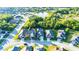 Aerial view of a home in a residential neighborhood, surrounded by lush greenery and ponds at 30647 Walker Cup Pl, Wesley Chapel, FL 33543