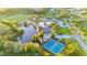 Aerial view of community including: pool, tennis courts, park, clubhouse, lake and green space at 30647 Walker Cup Pl, Wesley Chapel, FL 33543
