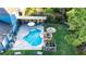 Aerial view of the pool, outdoor kitchen and bar, and backyard lawn at 30647 Walker Cup Pl, Wesley Chapel, FL 33543