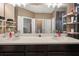This bathroom features a double sink vanity with dark cabinets and a large mirror at 30647 Walker Cup Pl, Wesley Chapel, FL 33543