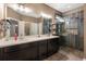 This bathroom features a double sink vanity and stand-up shower with decorative rock inset at 30647 Walker Cup Pl, Wesley Chapel, FL 33543