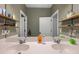 Bathroom vanity with double sinks, minimalist shelves, and a large mirror at 30647 Walker Cup Pl, Wesley Chapel, FL 33543