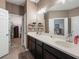This bathroom features a double sink vanity and doorway to the walk-in closet at 30647 Walker Cup Pl, Wesley Chapel, FL 33543