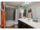 Charming bathroom features a shower-tub combo, decorative accents, and a modern vanity at 30647 Walker Cup Pl, Wesley Chapel, FL 33543