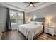 Bright bedroom featuring tray ceiling, neutral colors, and two bedside tables at 30647 Walker Cup Pl, Wesley Chapel, FL 33543