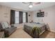 Cozy bedroom with a ceiling fan, comfortable seating, and neutral tones at 30647 Walker Cup Pl, Wesley Chapel, FL 33543