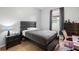 Bedroom with a wooden bed frame, neutral walls and a desk setup near the window at 30647 Walker Cup Pl, Wesley Chapel, FL 33543