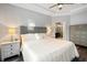 Well-lit bedroom featuring a comfortable bed, bedside tables, and an ensuite bath at 30647 Walker Cup Pl, Wesley Chapel, FL 33543