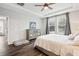 This bedroom offers natural light, tray ceiling, and wood-look floors and a gray dresser at 30647 Walker Cup Pl, Wesley Chapel, FL 33543