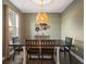 Dining room featuring a rustic wooden table with six chairs and decorative wall art at 30647 Walker Cup Pl, Wesley Chapel, FL 33543