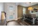 Cozy dining area next to the front door, featuring stylish decor and a rustic table at 30647 Walker Cup Pl, Wesley Chapel, FL 33543