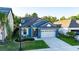Elevated view of a lovely blue home with manicured lawn and a two-car garage at 30647 Walker Cup Pl, Wesley Chapel, FL 33543