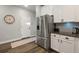 Contemporary kitchen with stainless steel refrigerator, white cabinets, and wood flooring at 30647 Walker Cup Pl, Wesley Chapel, FL 33543