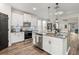 Modern kitchen with stainless steel appliances, white cabinets, and a large island at 30647 Walker Cup Pl, Wesley Chapel, FL 33543