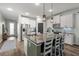 Bright kitchen with a granite island, stainless steel appliances, and white cabinetry at 30647 Walker Cup Pl, Wesley Chapel, FL 33543