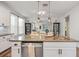 Kitchen featuring a large island with a sink, stainless steel dishwasher, and pendant lighting at 30647 Walker Cup Pl, Wesley Chapel, FL 33543