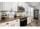 Well-equipped kitchen with modern appliances, granite countertops, and white tile backsplash at 30647 Walker Cup Pl, Wesley Chapel, FL 33543
