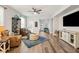 Inviting living room with a ceiling fan, comfortable seating, and wood flooring at 30647 Walker Cup Pl, Wesley Chapel, FL 33543