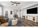 Comfortable living room featuring wood floors, natural light, and seamless flow to the staircase at 30647 Walker Cup Pl, Wesley Chapel, FL 33543