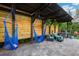 Relaxing patio with blue hammocks, comfortable seating, and an outdoor grill at 30647 Walker Cup Pl, Wesley Chapel, FL 33543