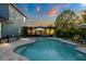 Inviting backyard pool featuring a pergola, cozy seating, and well-maintained landscaping, perfect for relaxation at 30647 Walker Cup Pl, Wesley Chapel, FL 33543